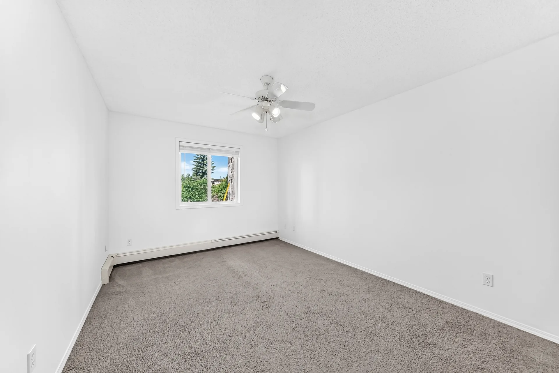 Bedroom with window and ceiling fan