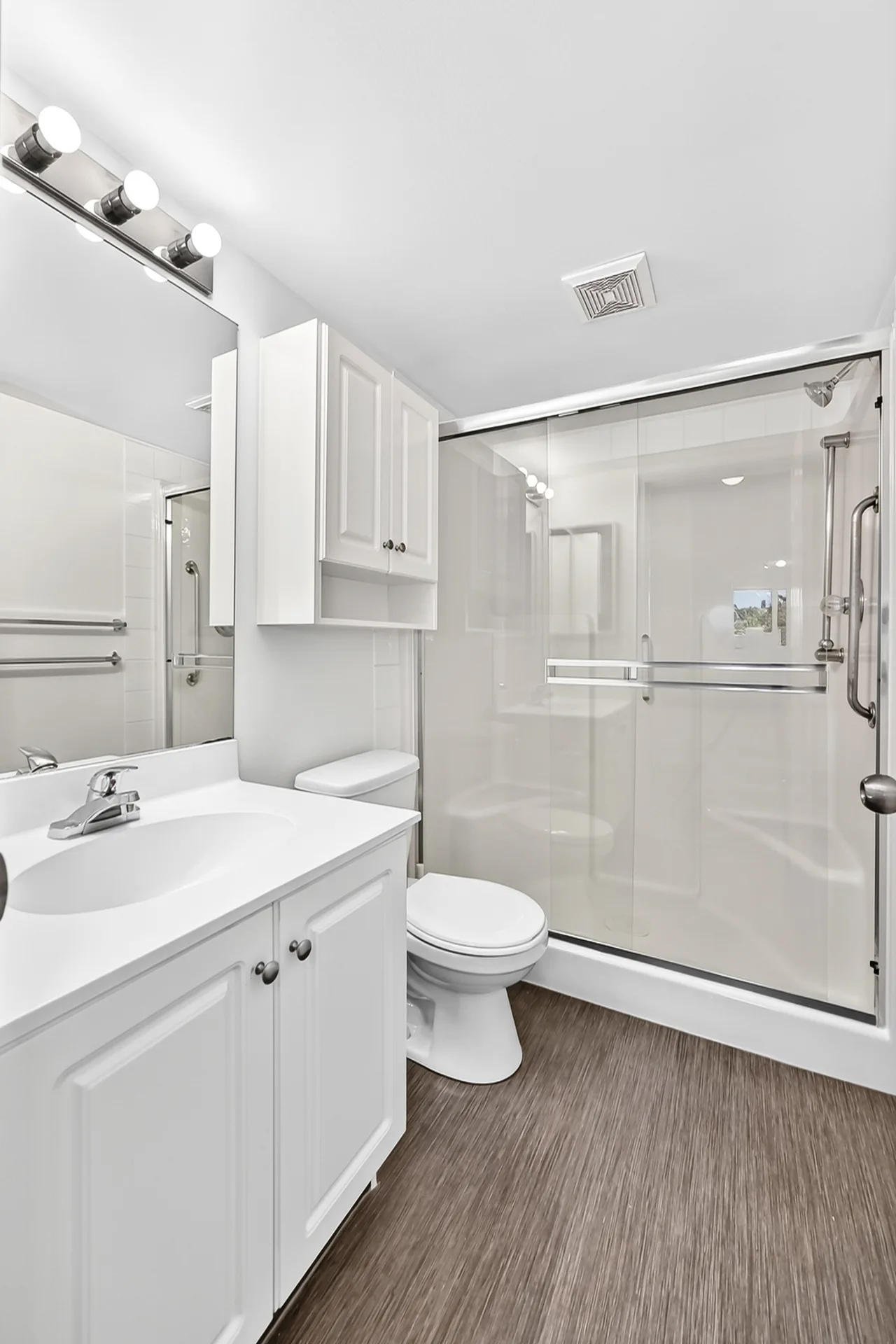 Bathroom with white vanity and glass shower