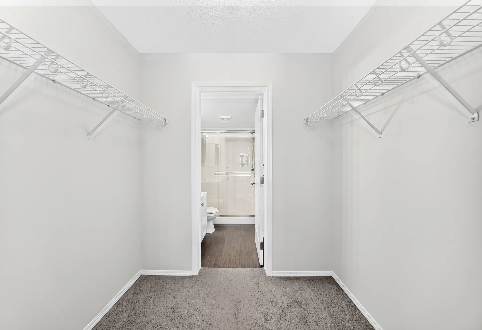 Primary walk-in closet with wire shelving