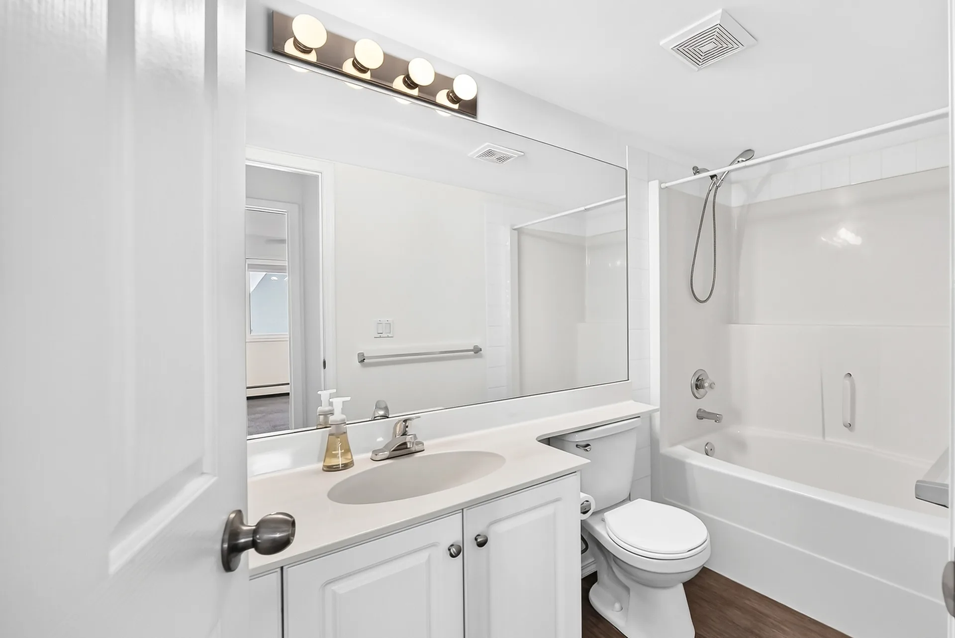 Bathroom with white vanity and tub-shower combo