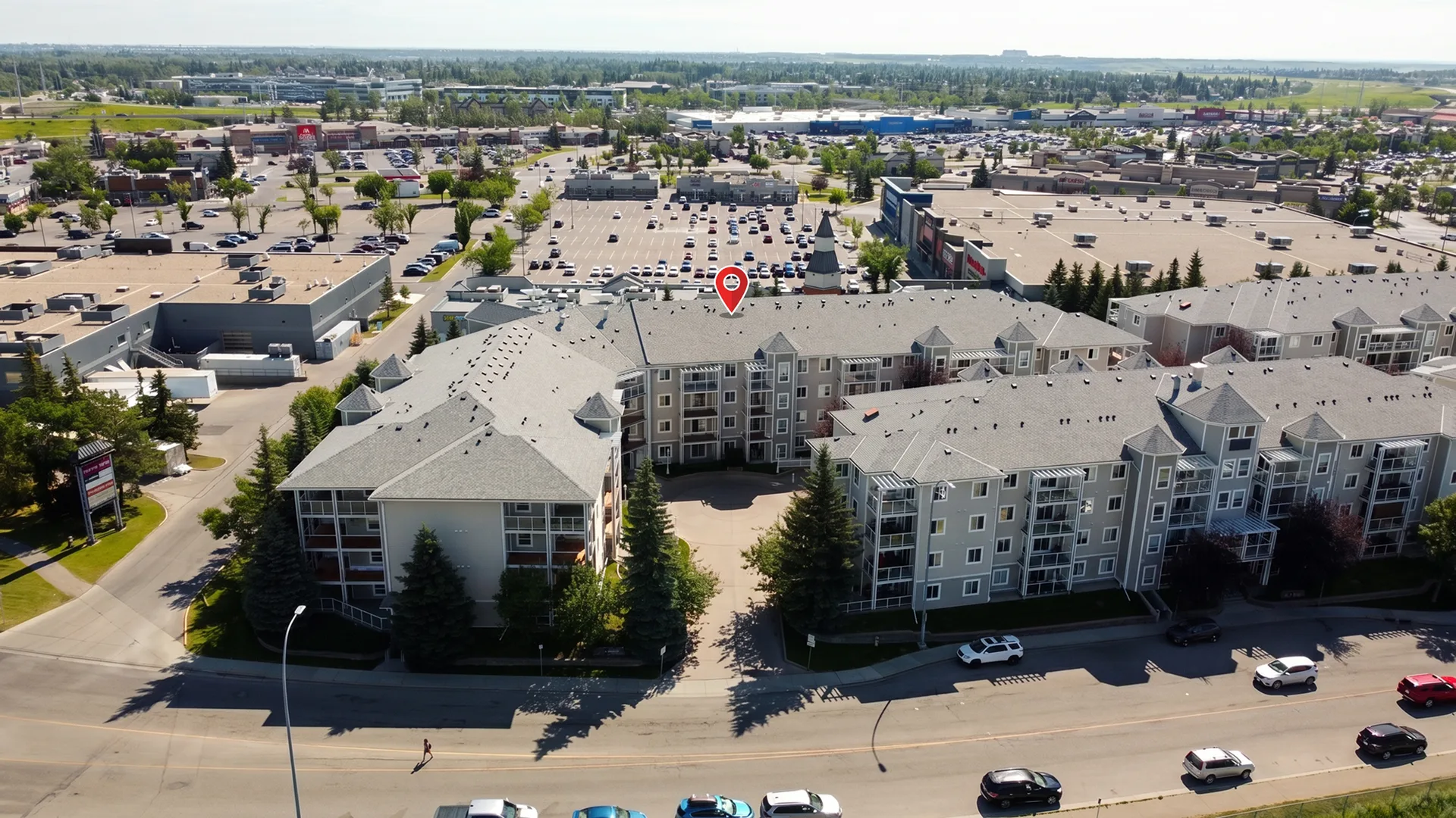 Aerial view of condo complex and shopping plaza