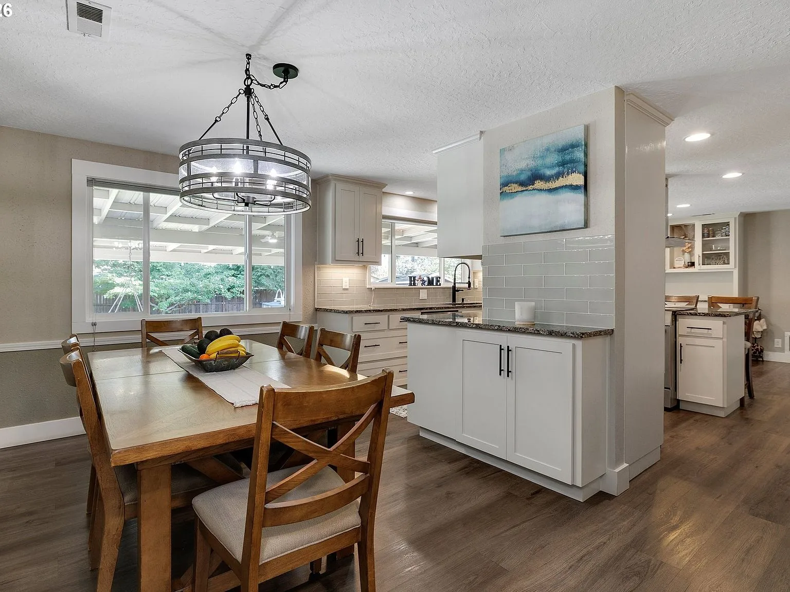 Dining area looking toward the kitchen with chandelier
