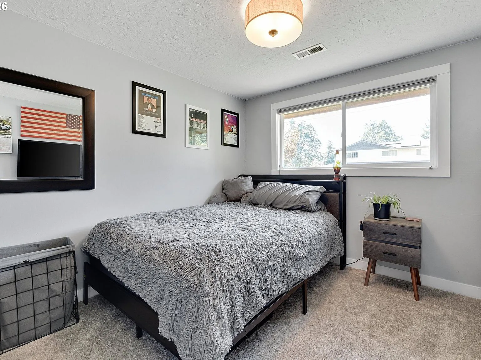 Secondary bedroom with light grey walls and window blinds