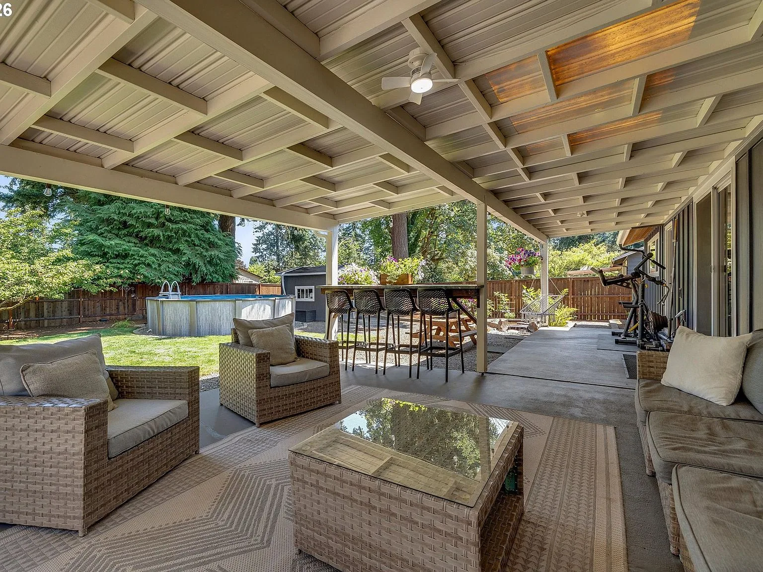 Covered patio area with metal roof and concrete floor
