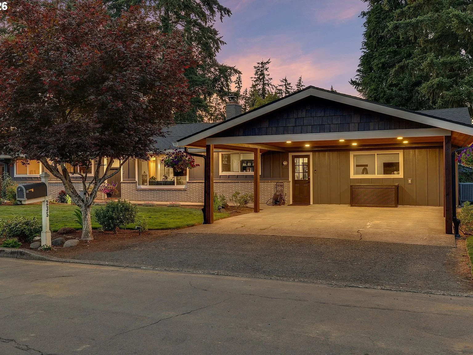 235 Barclay Ave exterior at dusk with warm interior lighting and landscaped front yard