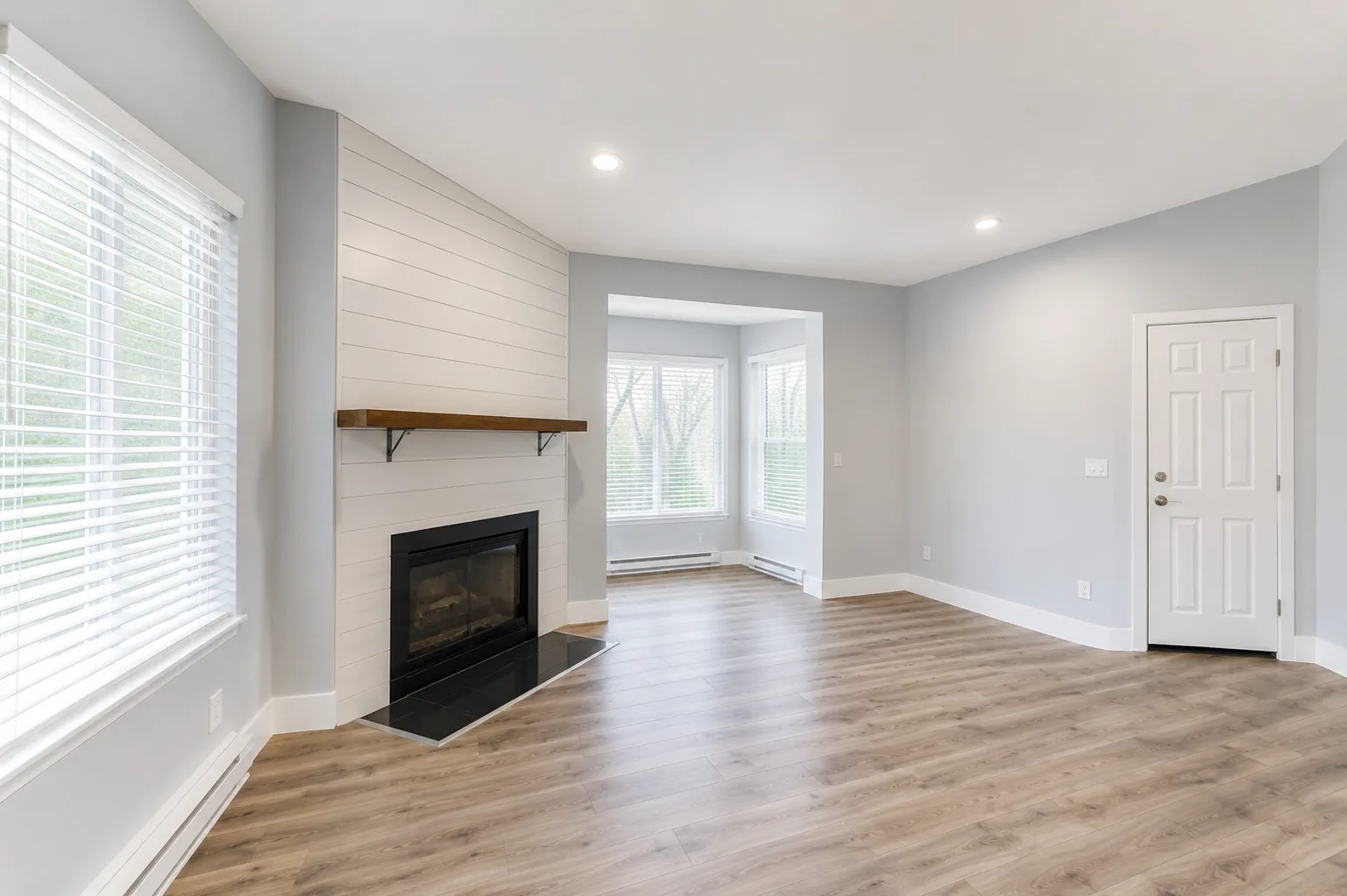 Living room with shiplap fireplace surround and natural light