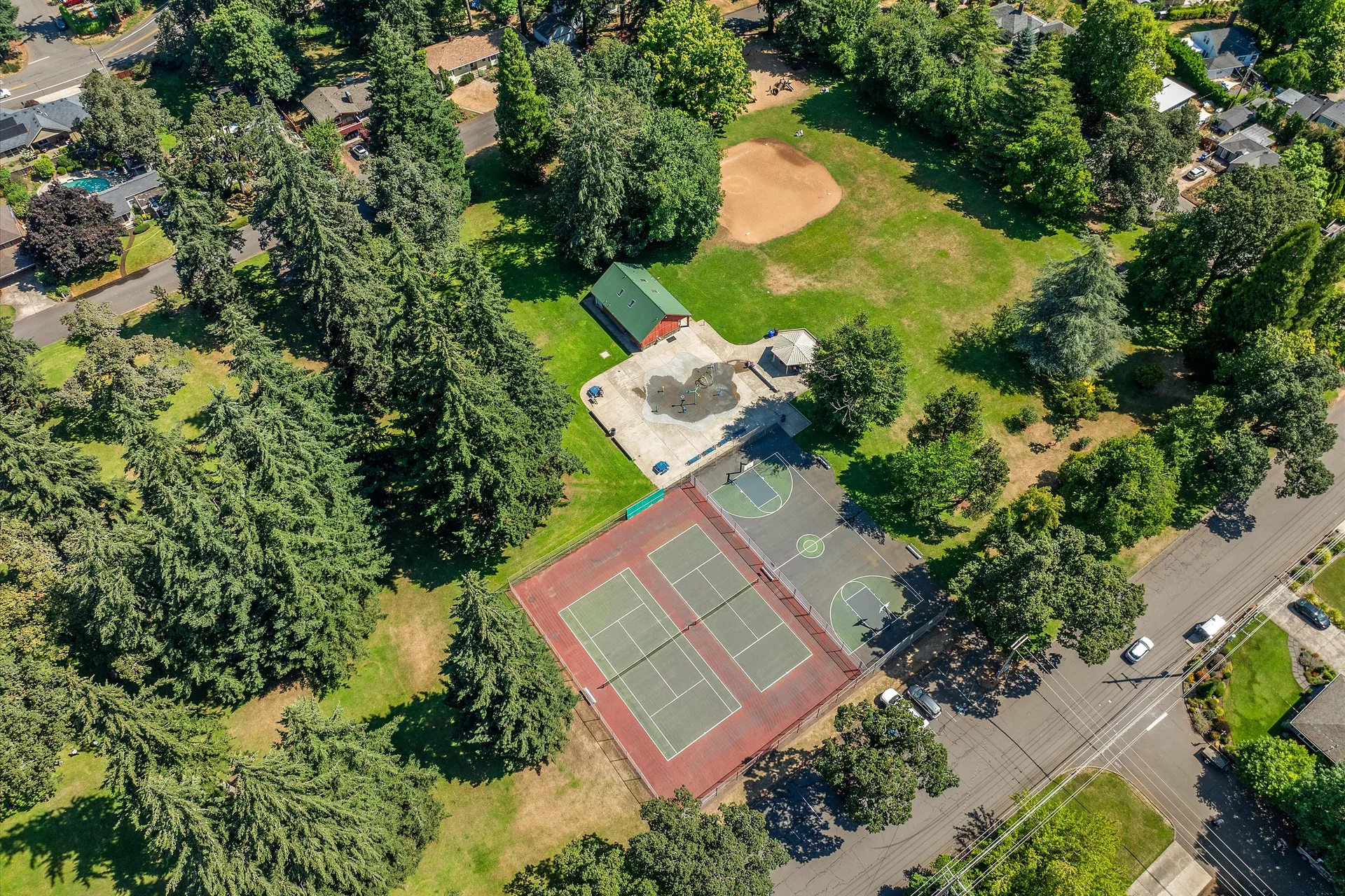 Drone shot of Rivercrest Park with tennis and basketball courts