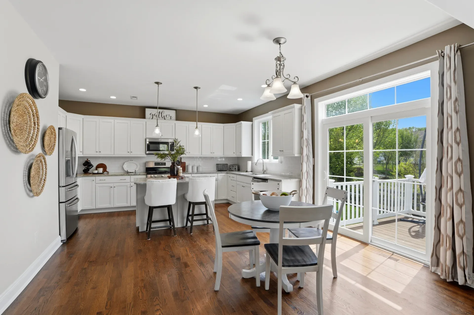 Kitchen with white cabinetry and large sliding glass door bringing in natural daylight