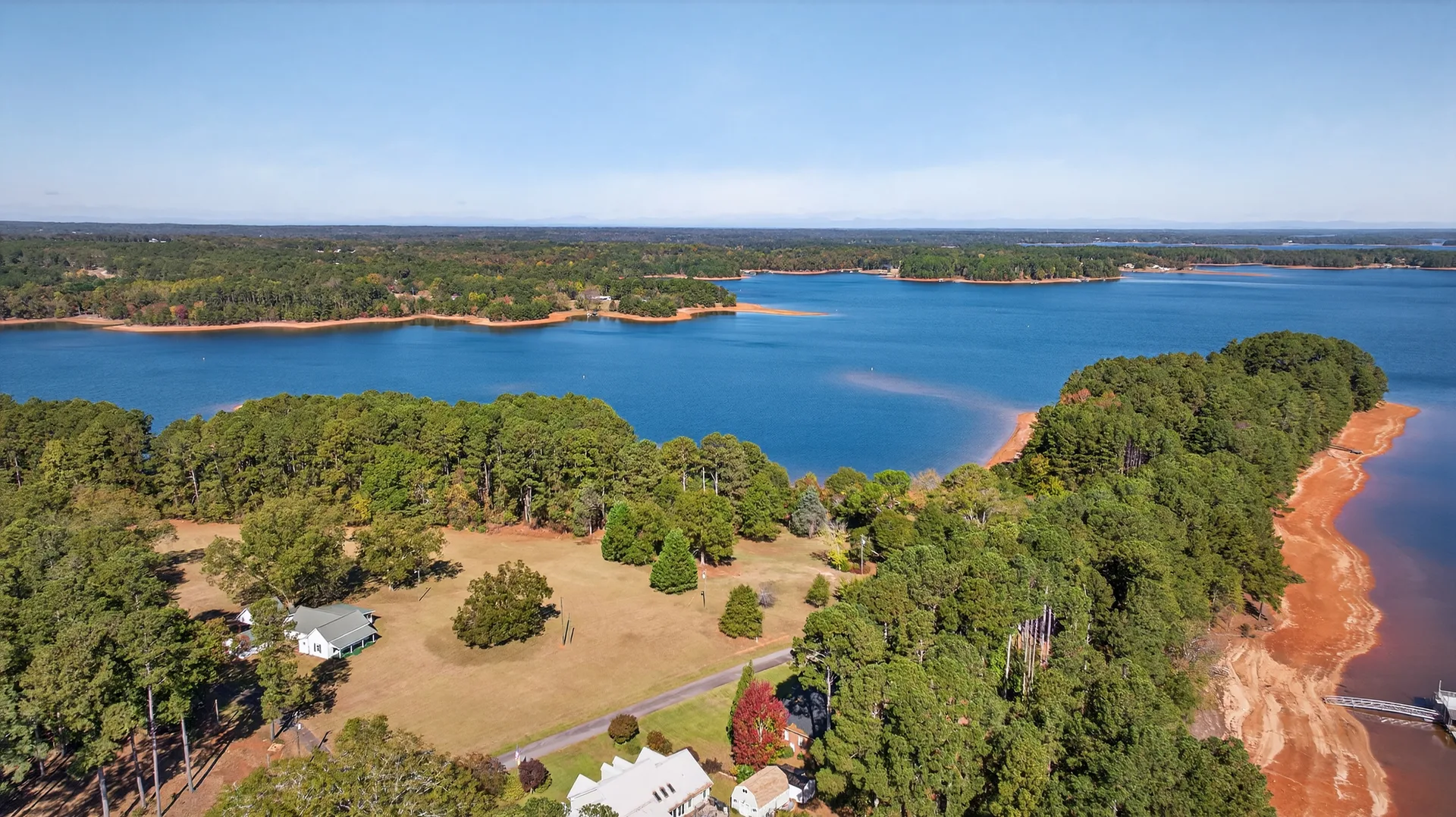 Aerial wide-angle view of the Lake Hartwell shoreline with forested banks and calm blue water