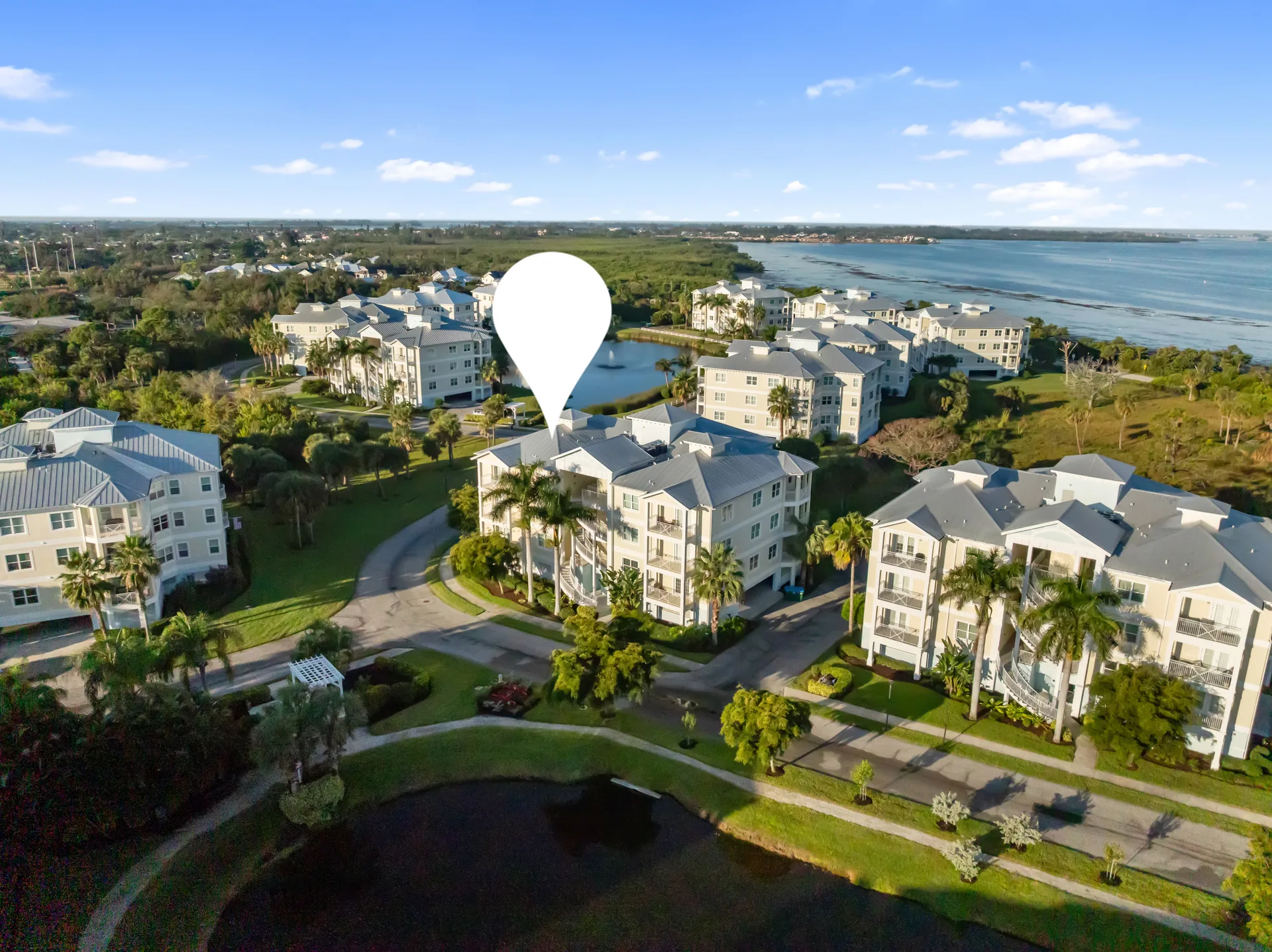 Aerial view of the Palma Sola Bay Club condo complex in Bradenton, Florida with its resort-style buildings, pools, and bayfront location