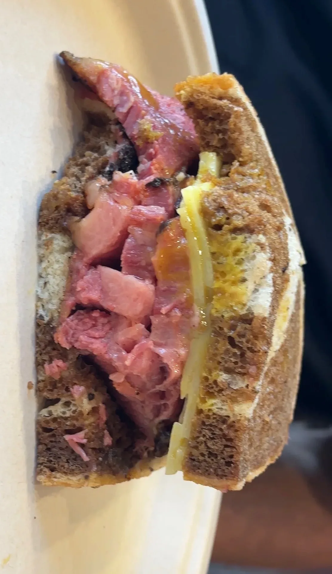 Close-up of the Brisket Pastrami Special sandwich at Whistle Q in Flowery Branch Georgia, house-cured Certified Angus Beef on toasted marble rye