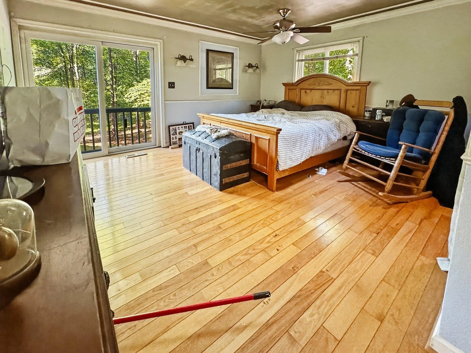 Primary bedroom with hardwood floors and sliding door access