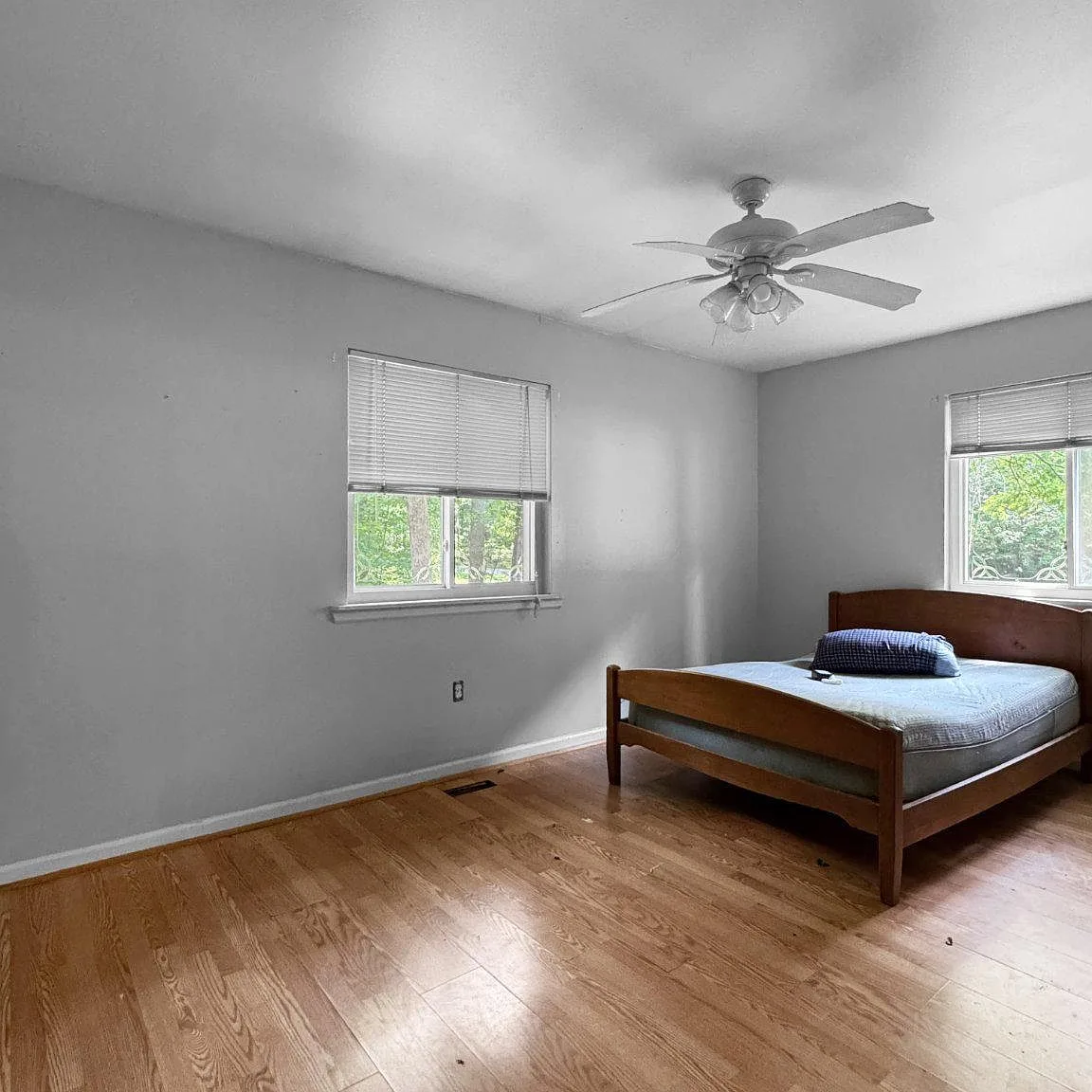 Bedroom with hardwood flooring and light gray walls
