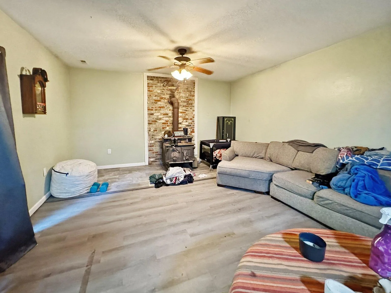Living room with wood-burning stove and brick accent wall