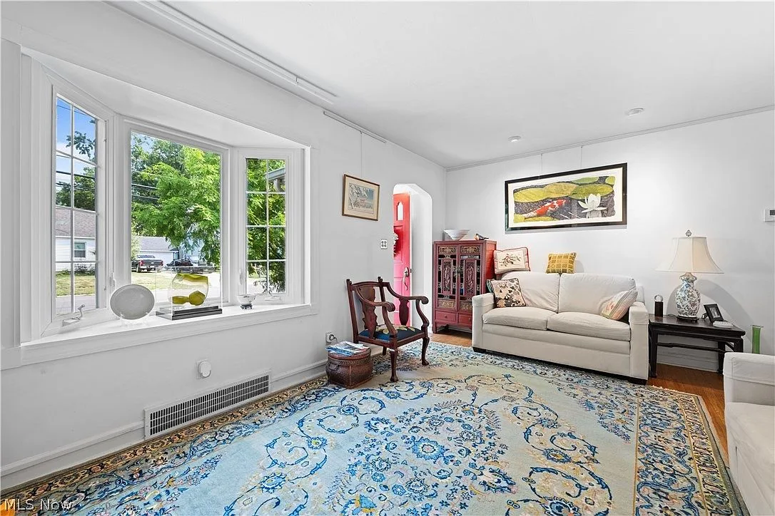 Living room showing large bay window and bright natural daylight