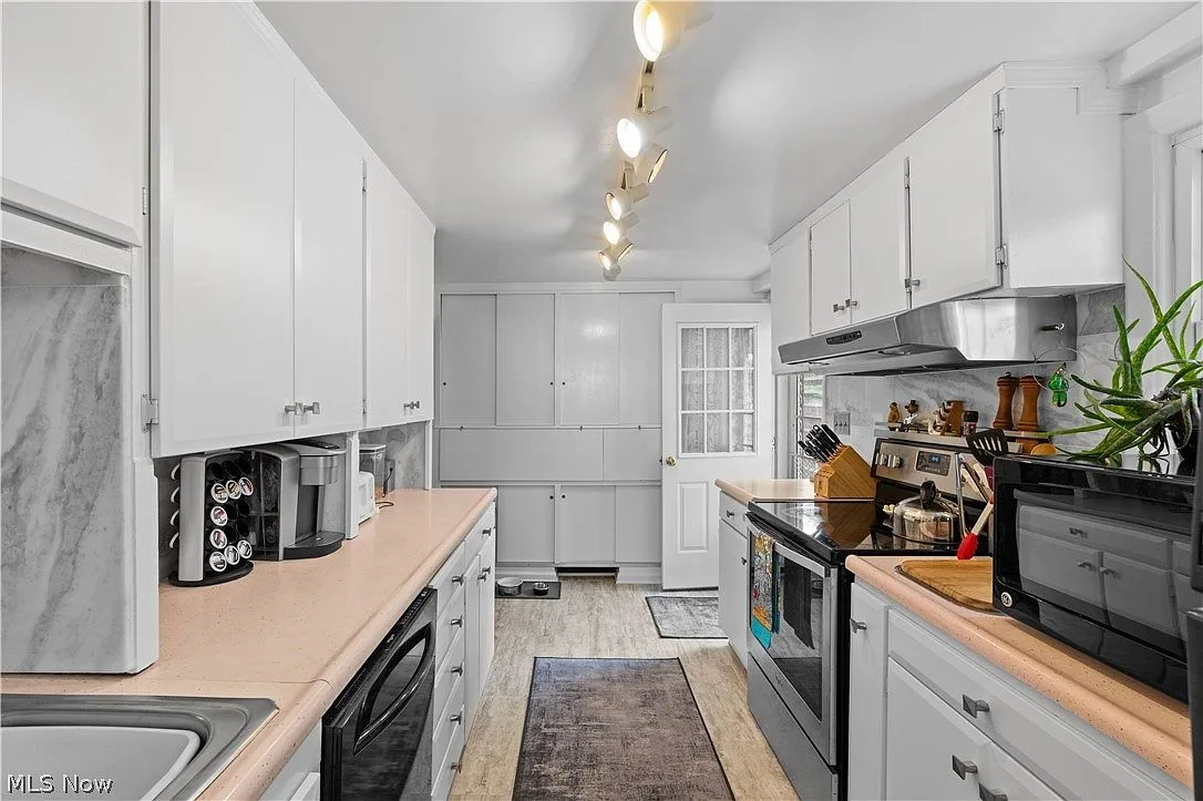 Galley kitchen with all appliances and abundant storage