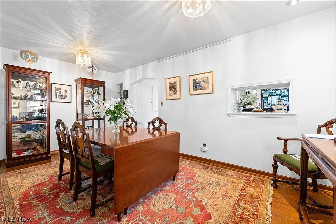 Formal dining room with hardwood floors and white walls