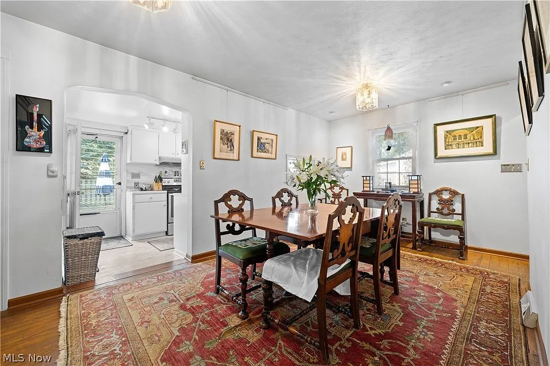 Dining room with console table and arched doorway to kitchen