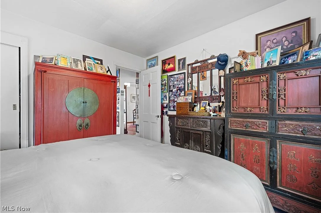 Main floor bedroom with neutral carpeting and natural lighting