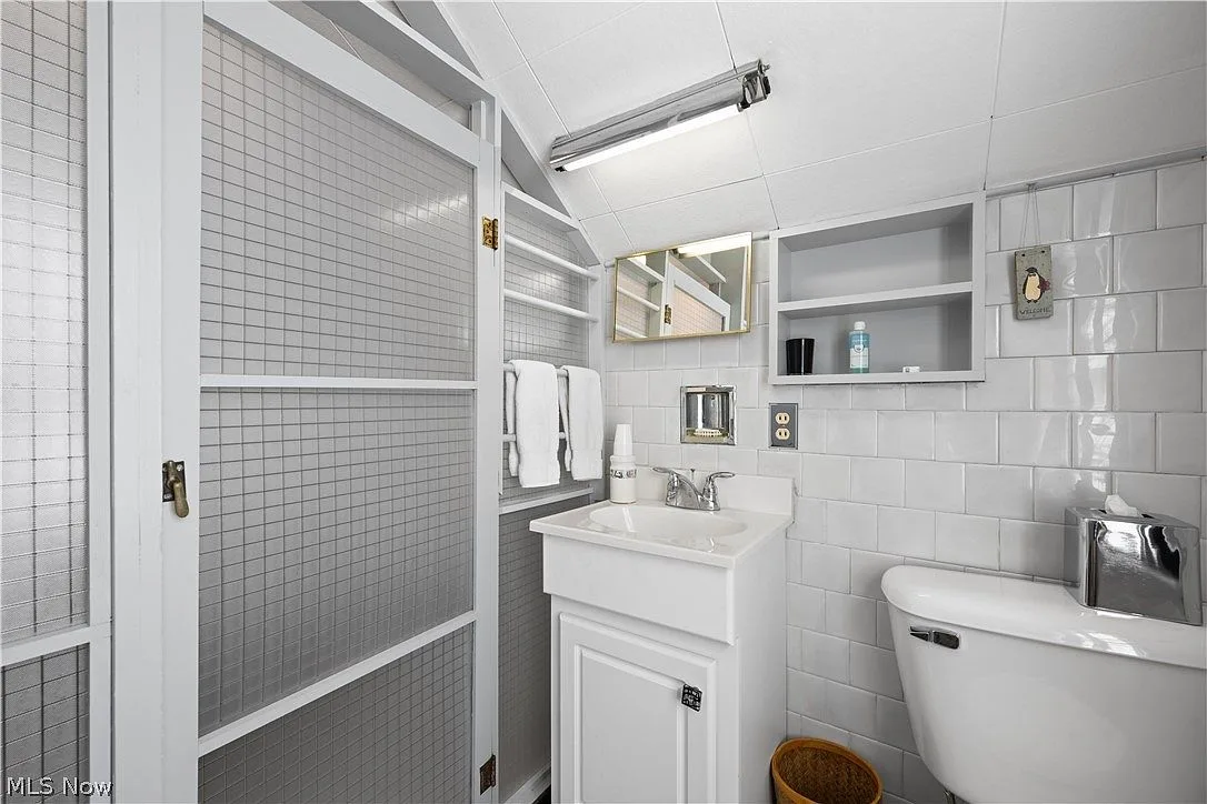 Upstairs bathroom vanity with checkered glass paneling