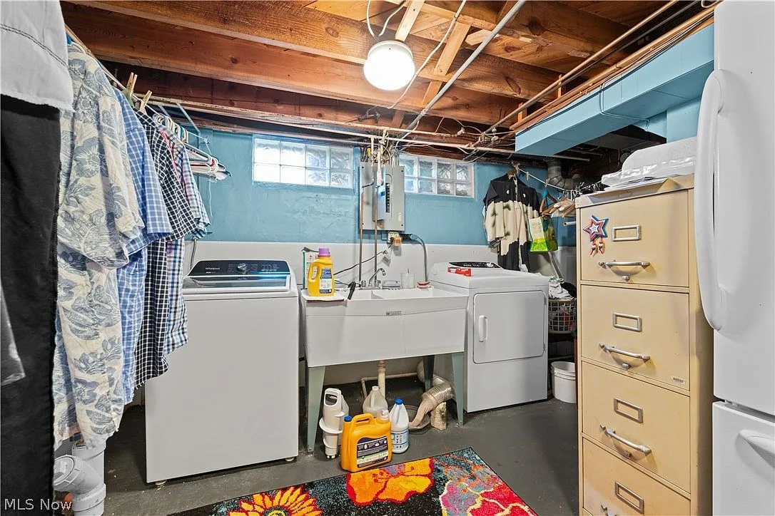Basement laundry and utility area with exposed ceiling joists