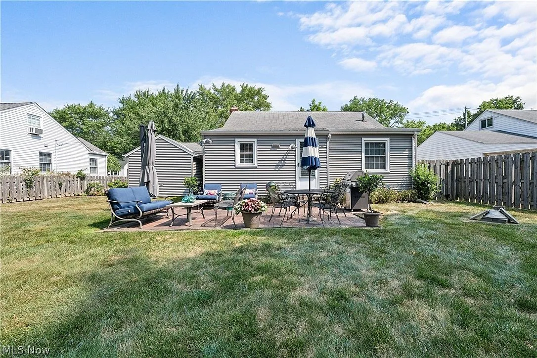 Rear exterior showing Cape Cod architecture and patio