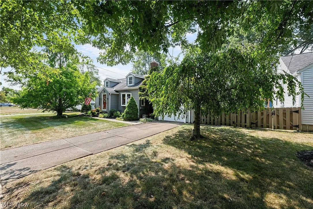 Angled view of 125 Jacqueline Dr exterior with mature trees