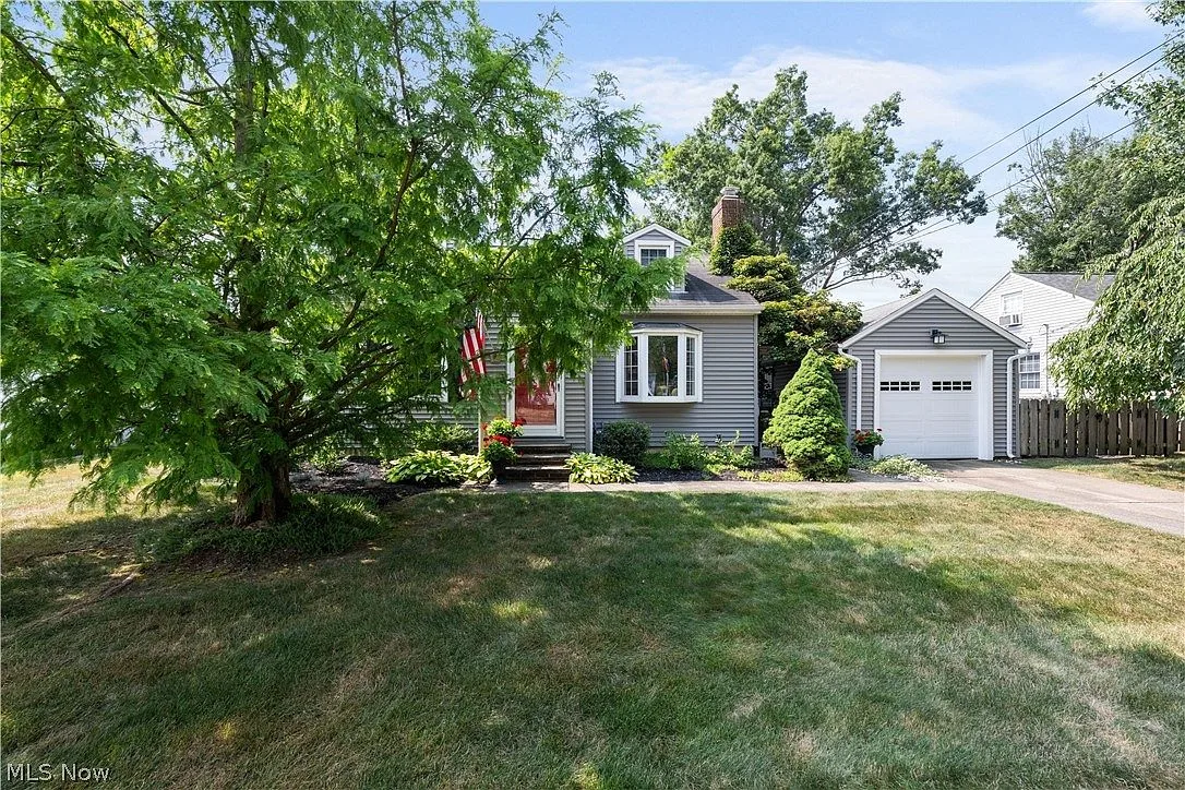 Cape Cod home at 125 Jacqueline Dr, Berea, OH showing gray siding and mature trees