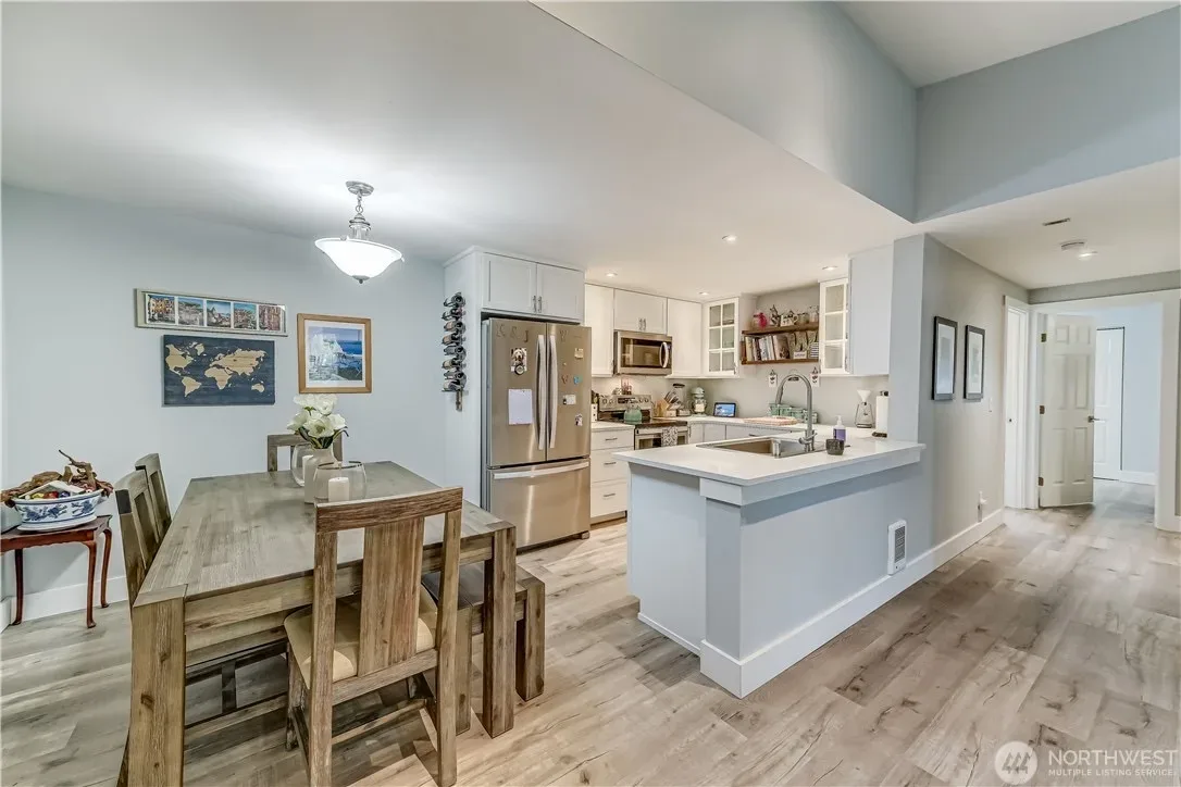 Dining area beside the open kitchen with wood-look flooring