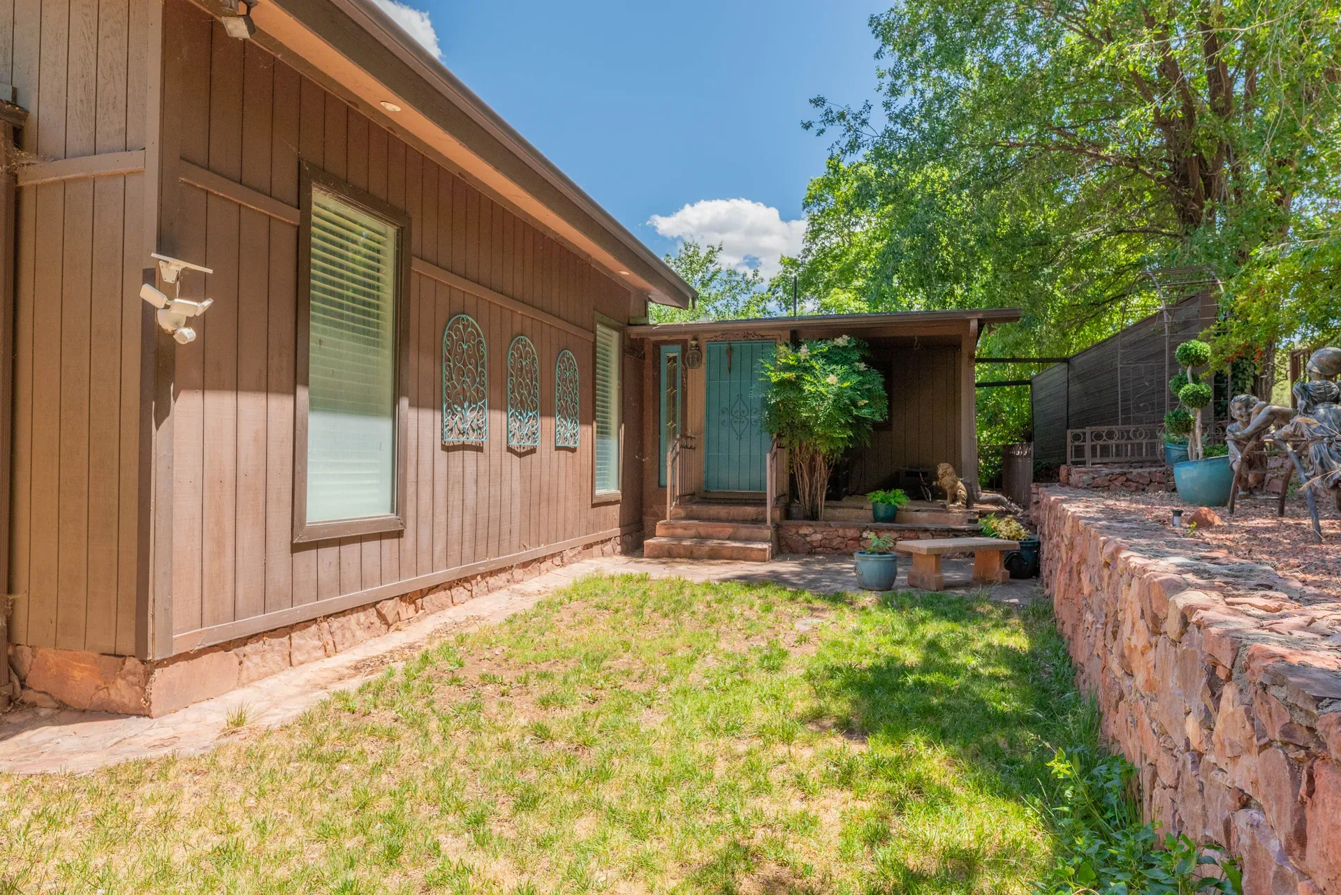Cabin unit with red rock stone masonry and blue door