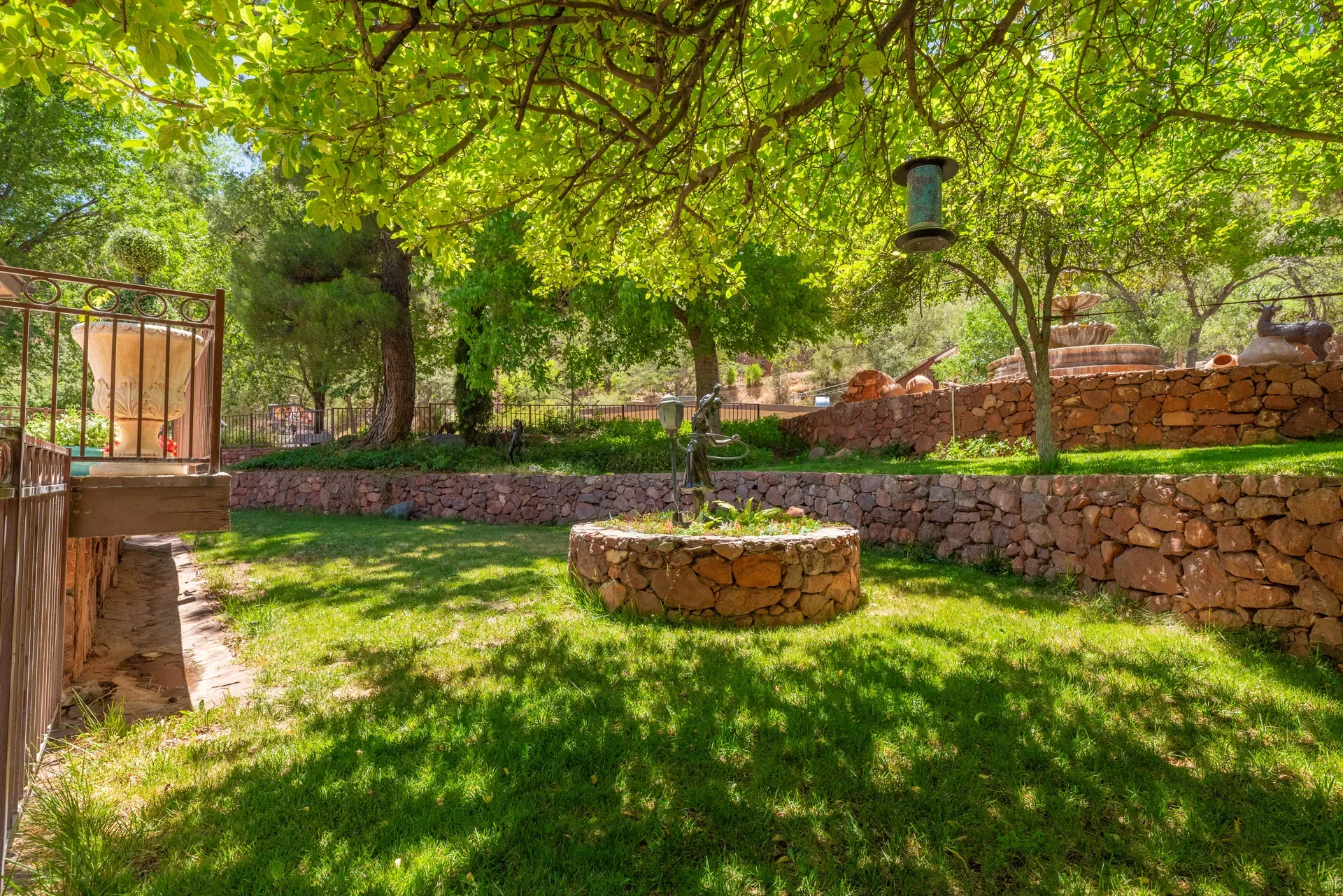 Backyard garden with stone walls and circular planter