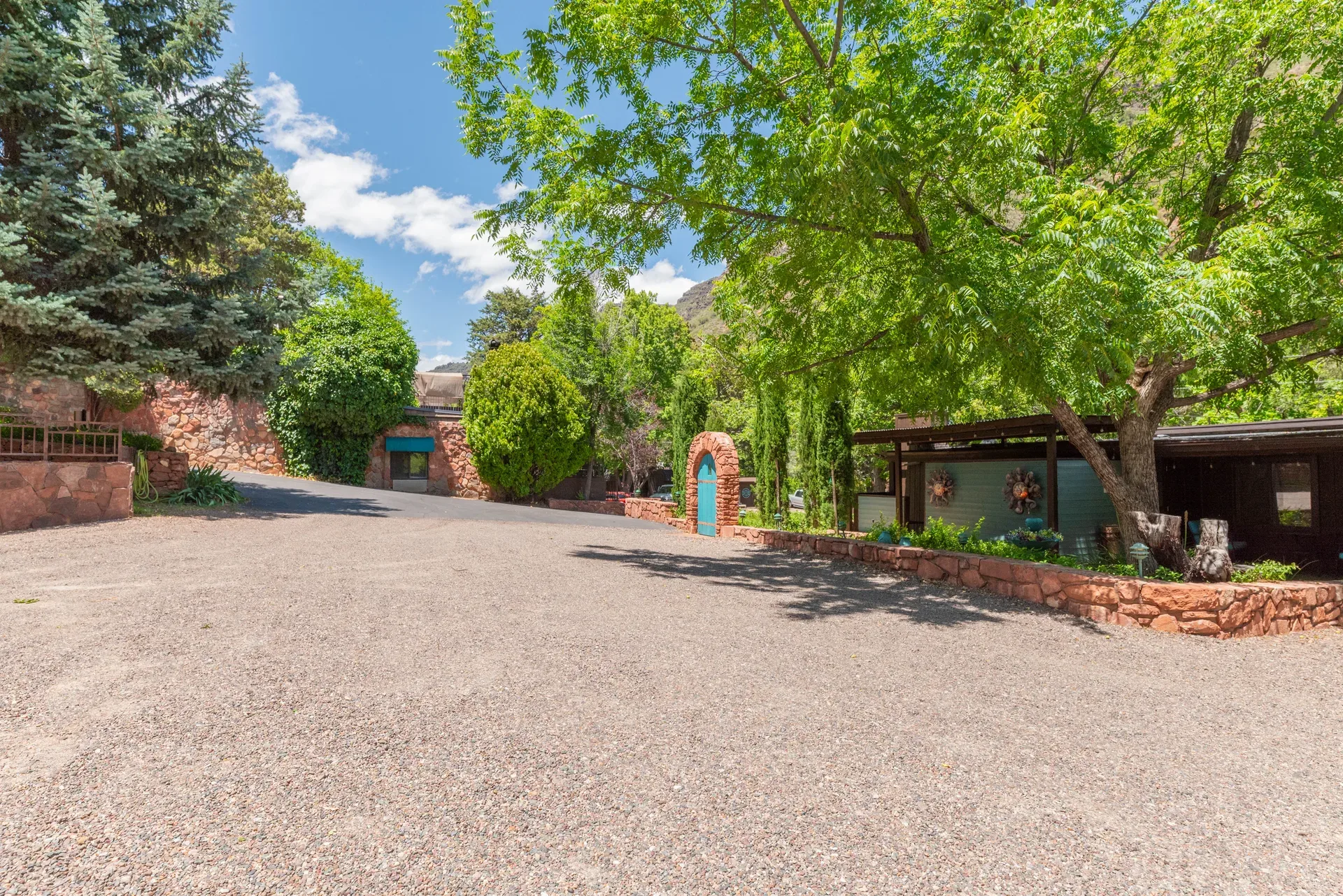 Resort approach with stone archway and mature landscaping