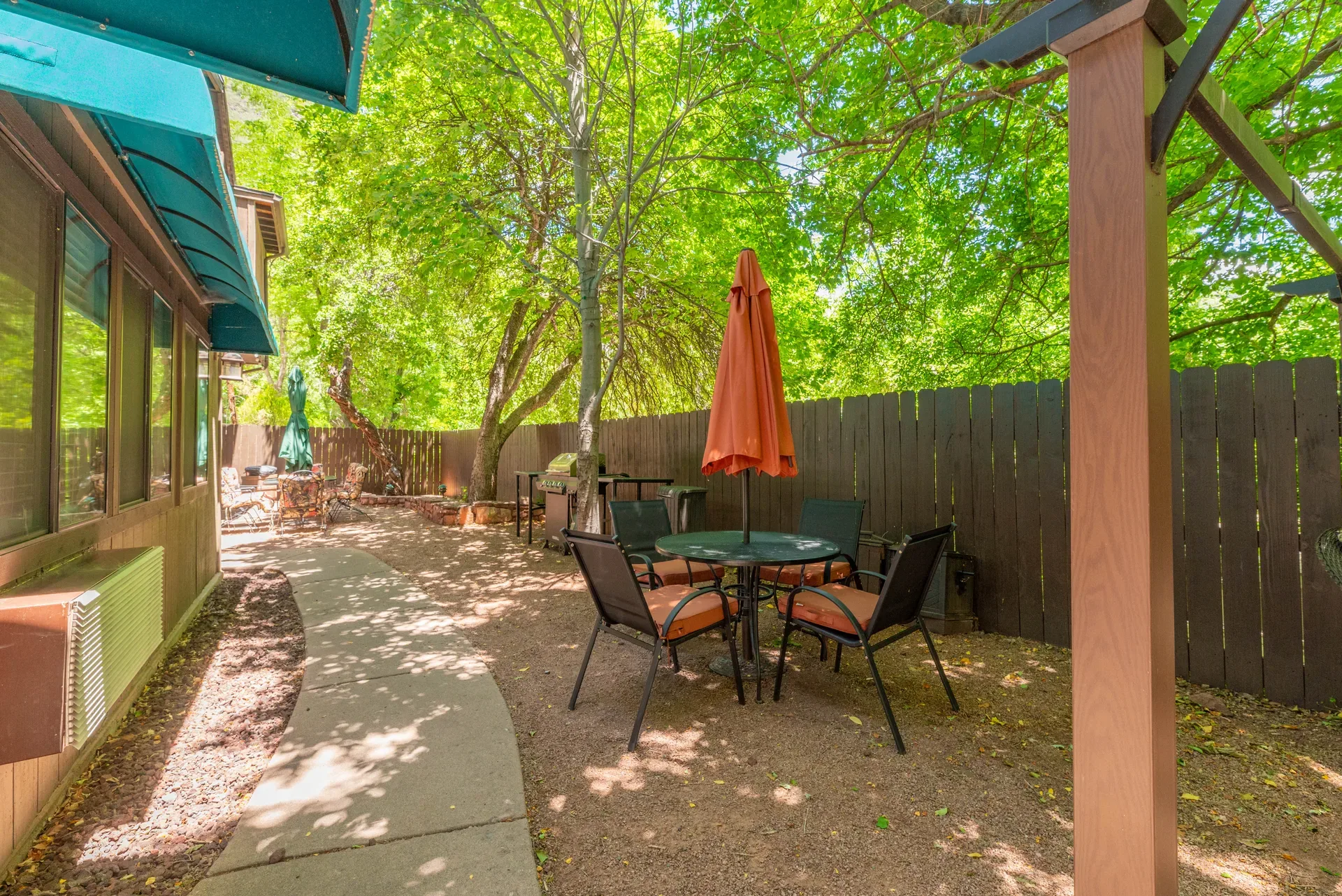 Outdoor patio with bistro table and orange umbrella