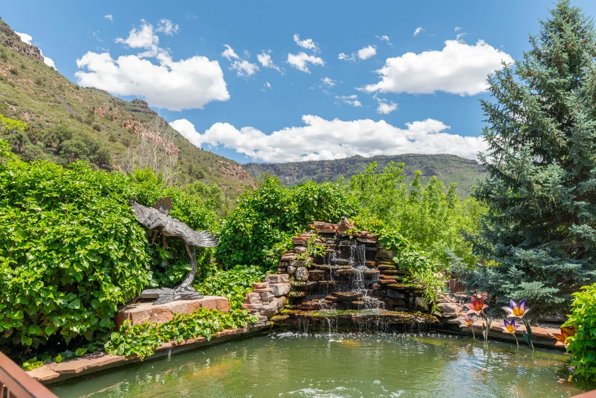 Stone-tiered waterfall and pond on resort grounds