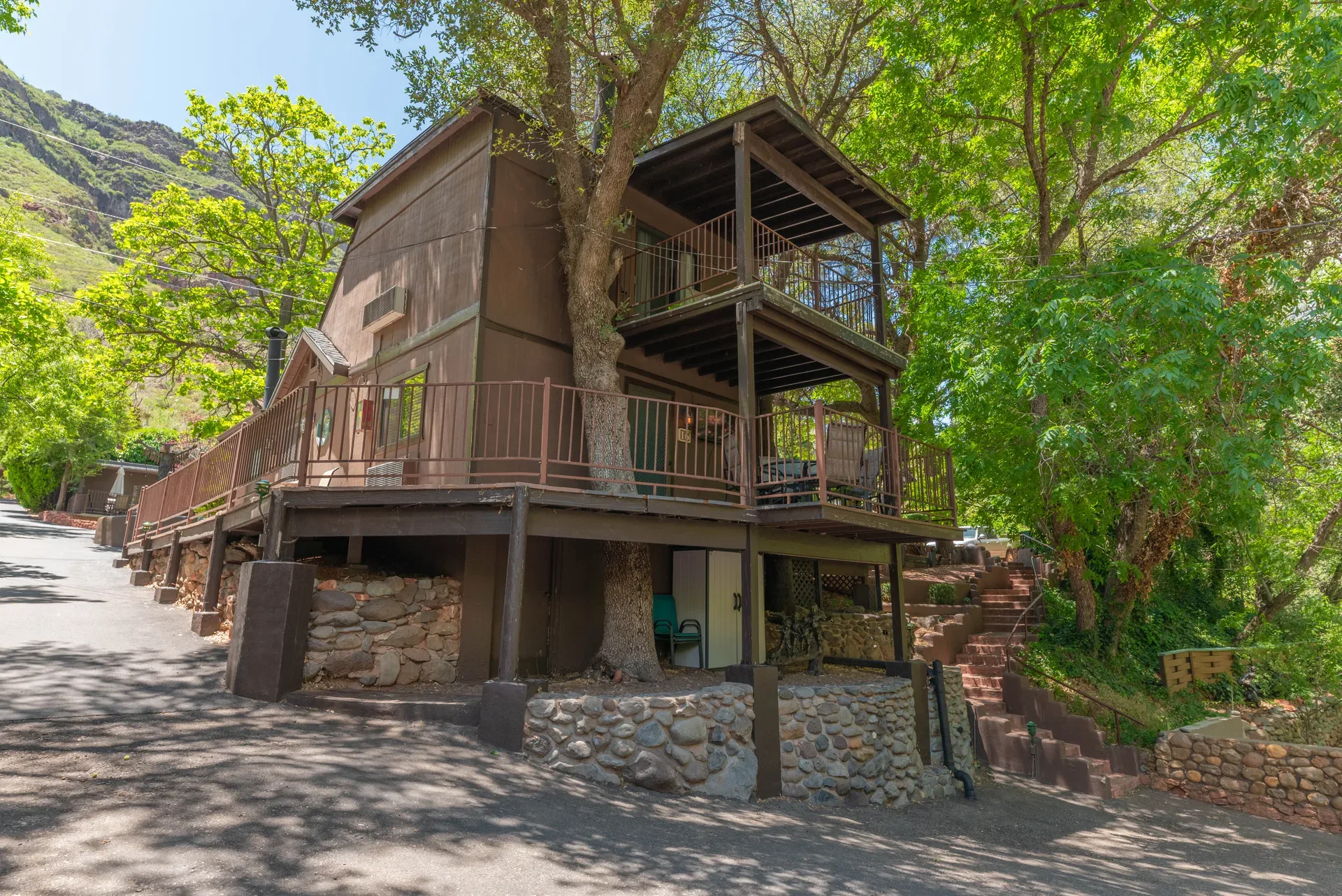 Two-story cabin facade with balconies and stone foundation
