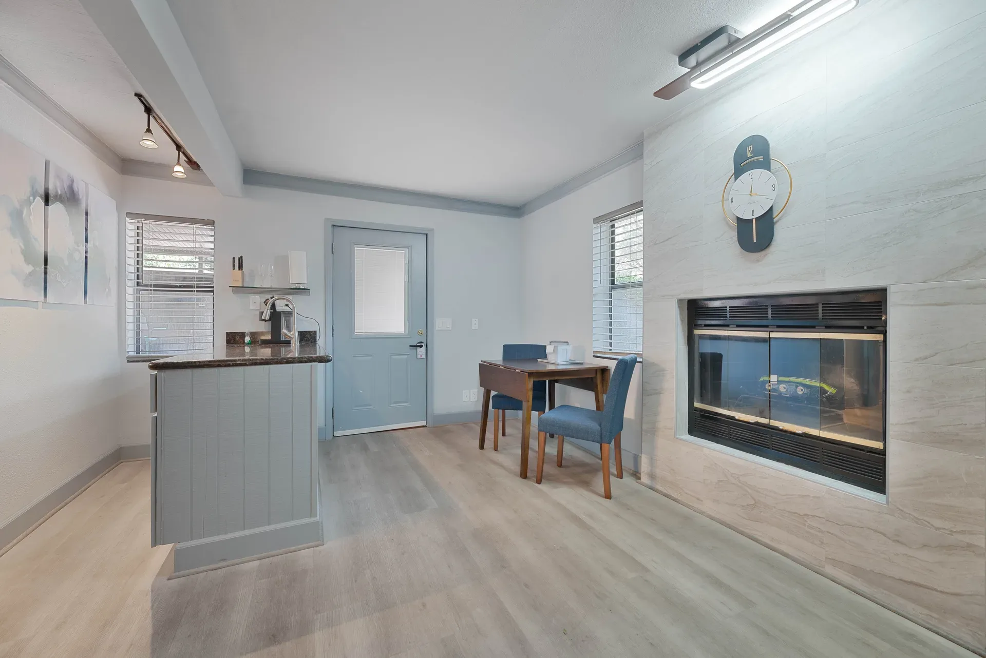 Open-plan resort unit with stone fireplace and kitchenette counter