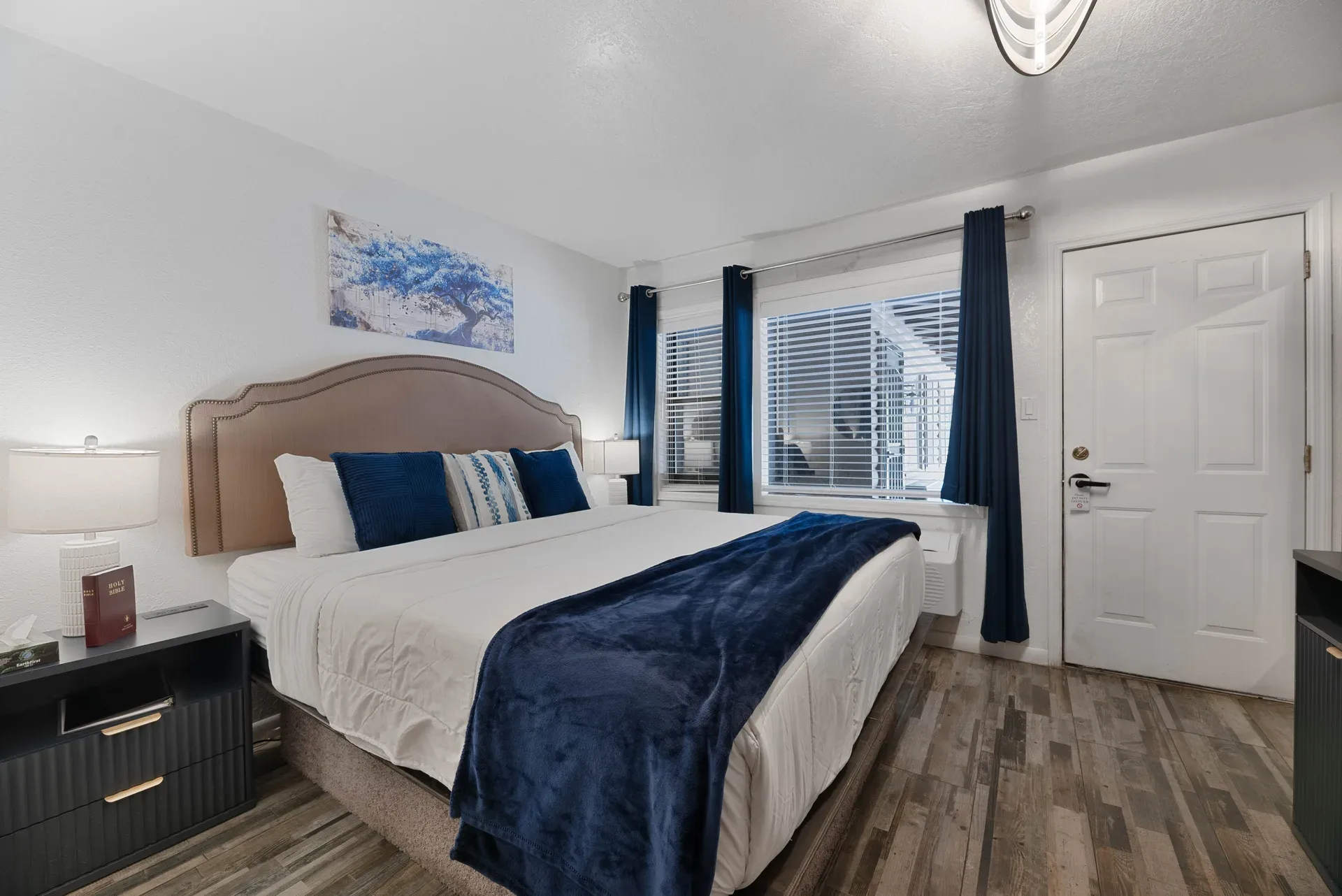 Bedroom with navy blue accents and upholstered headboard