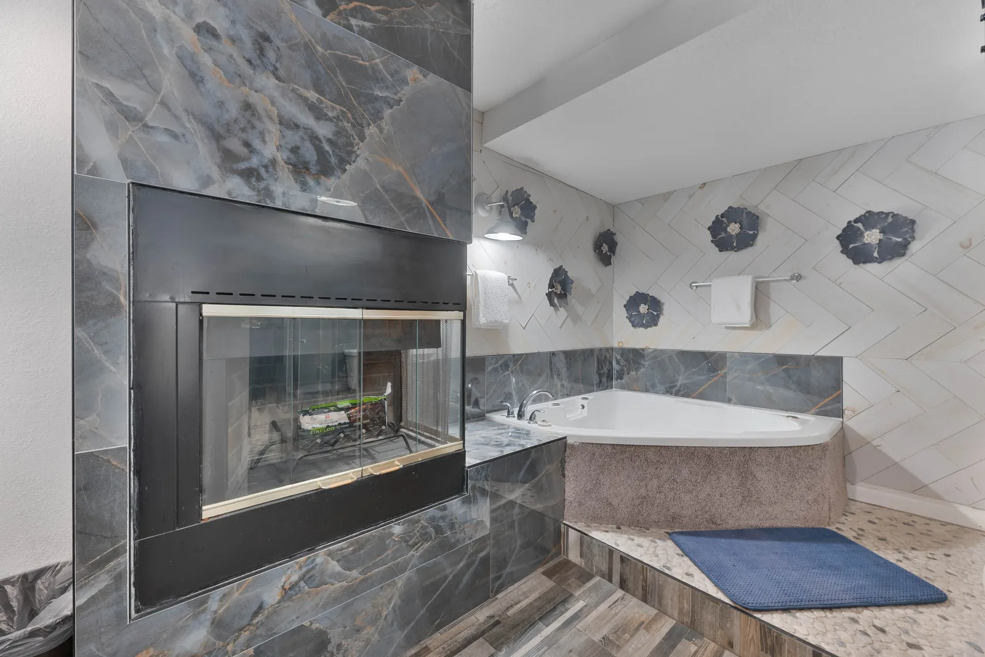 Luxury bathroom with marble fireplace surround and soaking tub