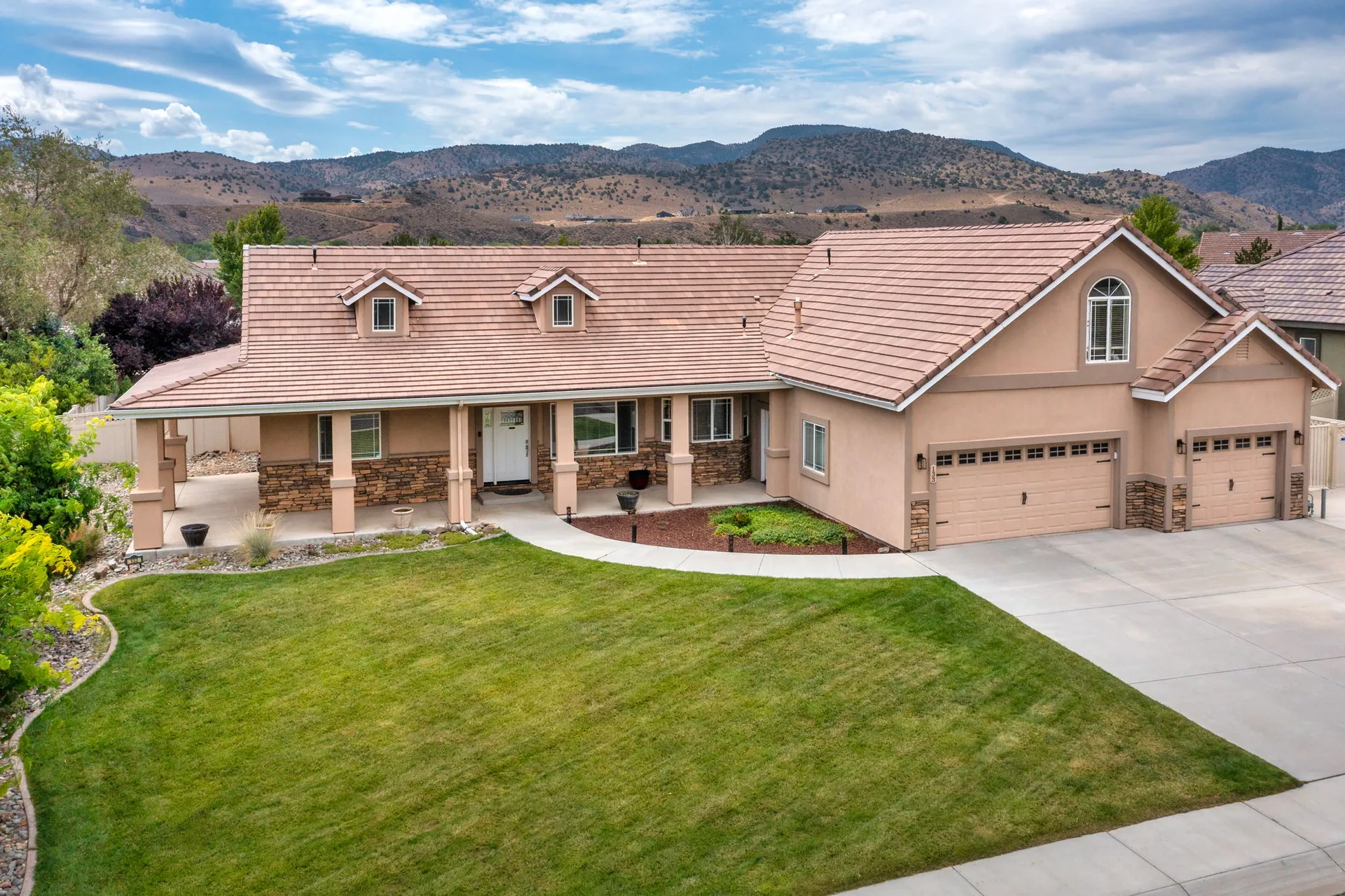 Front exterior of 133 Denio showing ranch-style architecture with stucco and stone facade