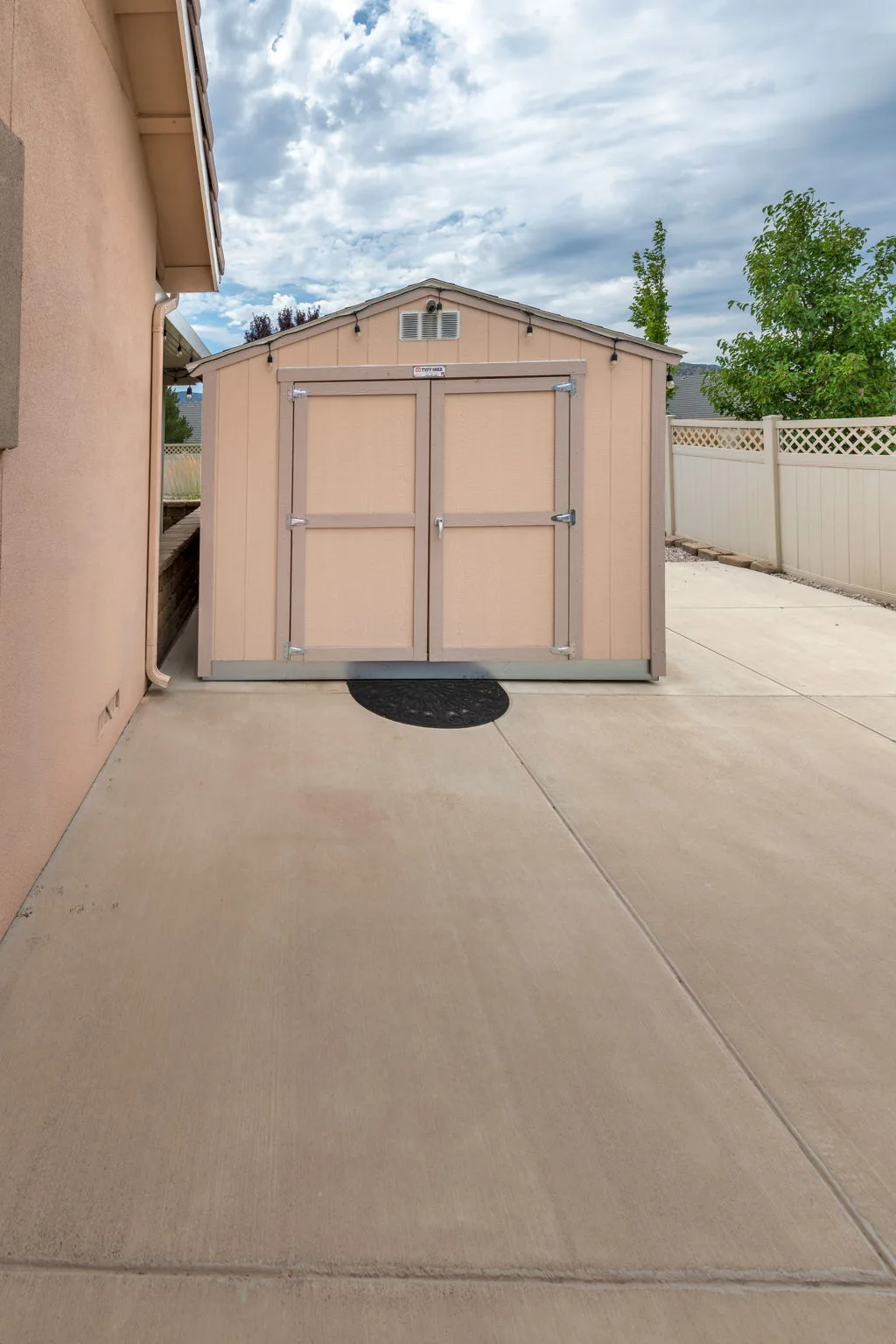 Backyard storage shed with privacy fencing