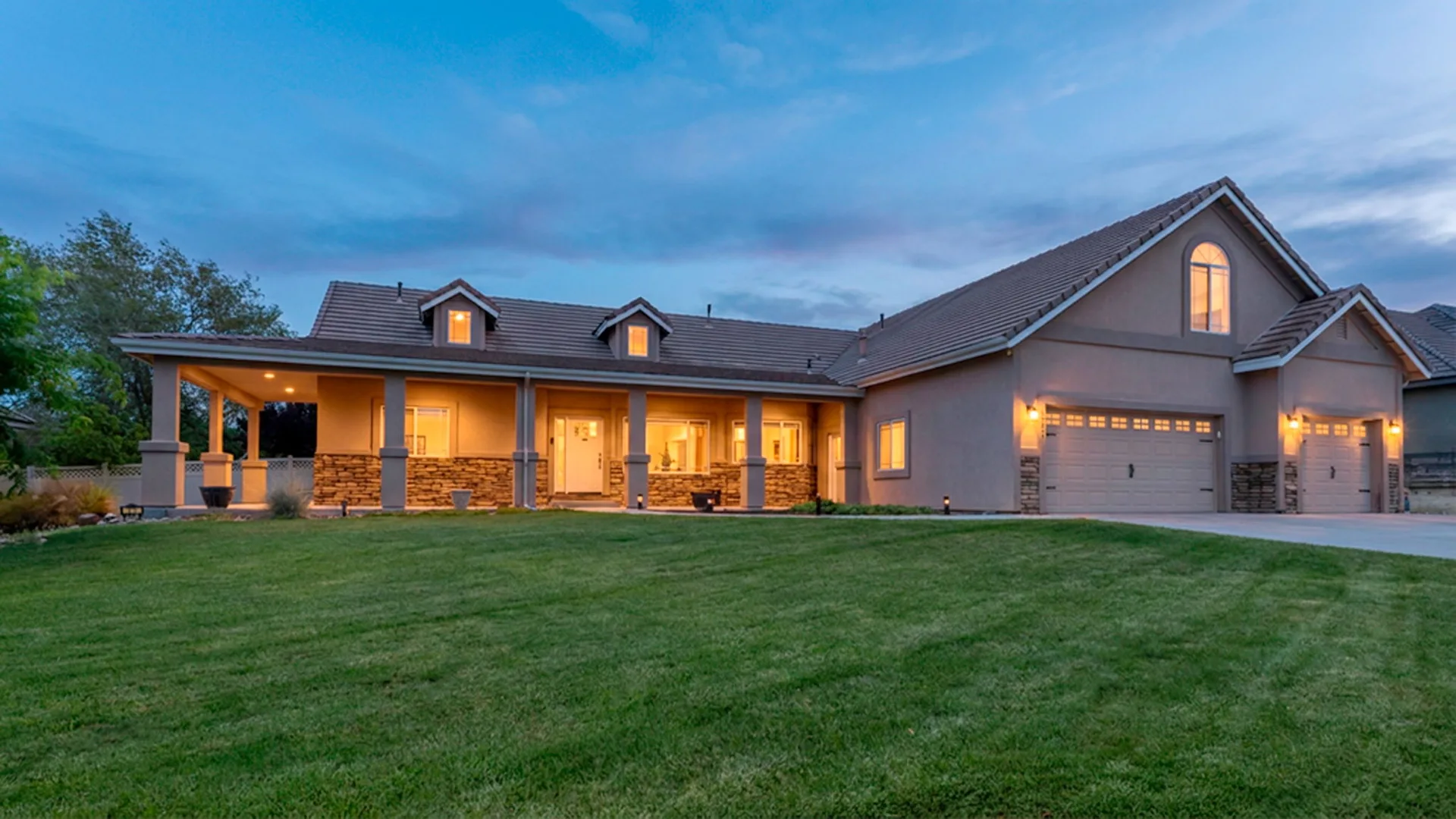 Twilight exterior view of 133 Denio, a ranch-style home with warm interior lighting