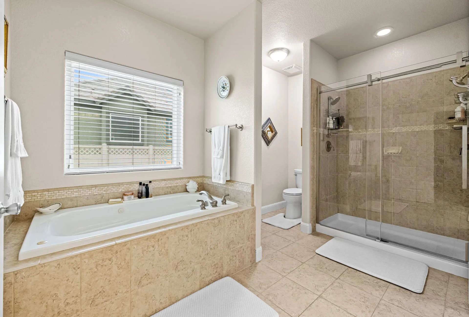 Primary bathroom with soaking tub and glass shower