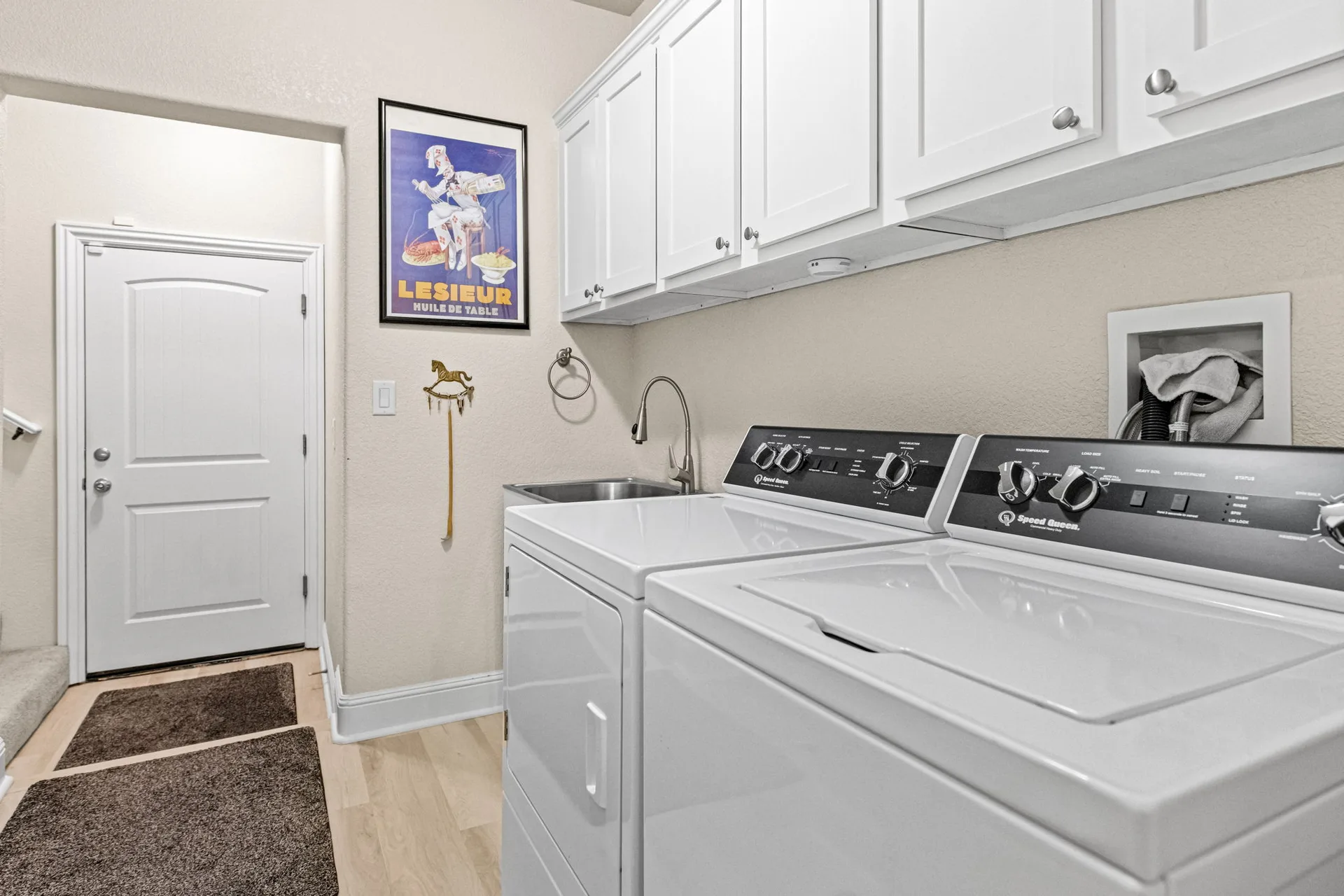 Laundry room with washer, dryer, and sink