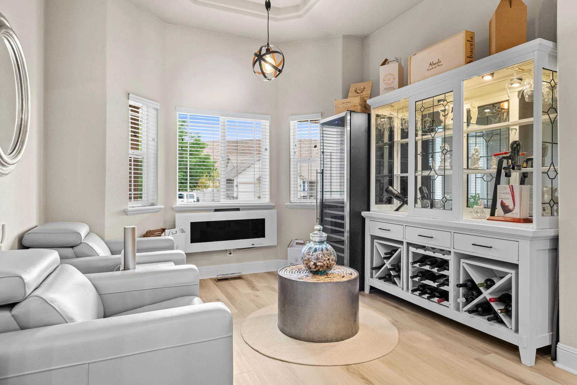 Lounge area with wood flooring and wine refrigerator