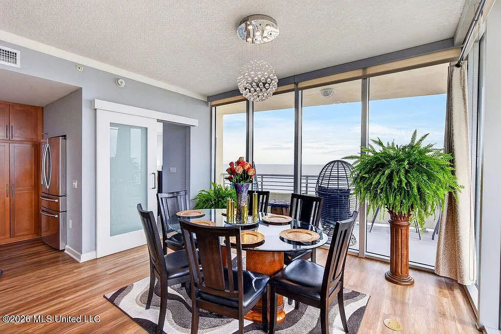 Dining area with panoramic ocean views through floor-to-ceiling windows
