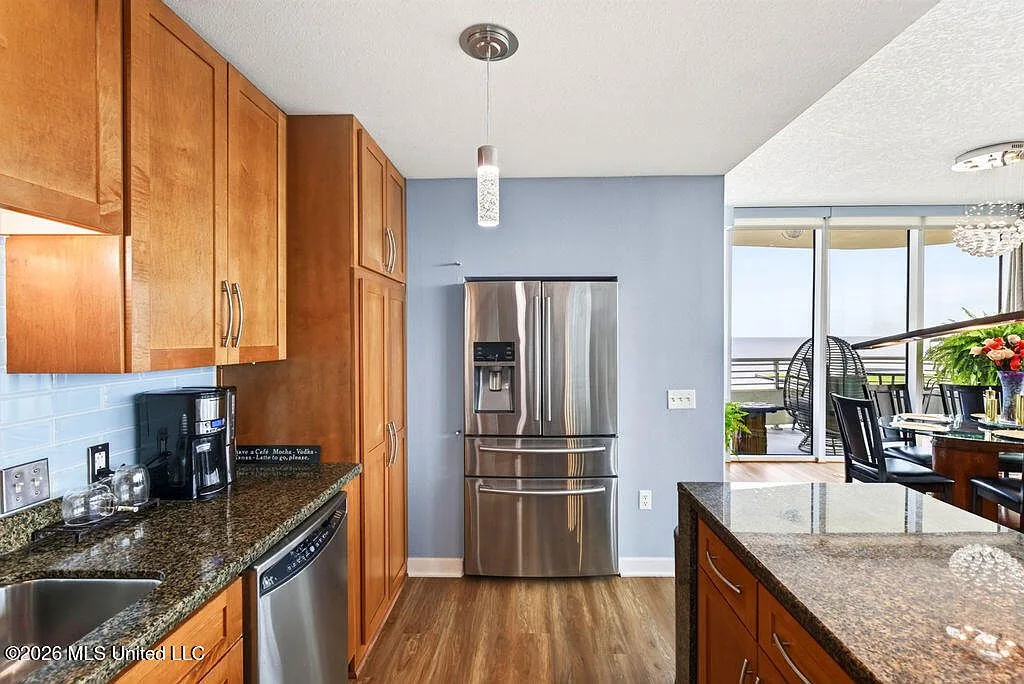Kitchen with view toward dining area and balcony