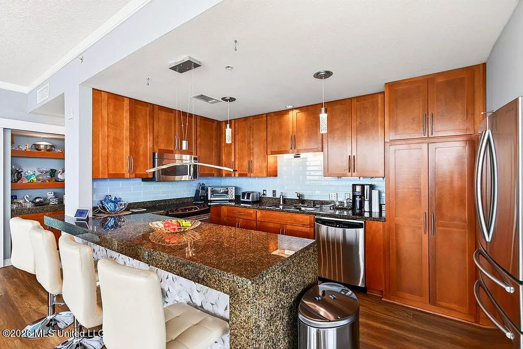 Updated kitchen with granite countertops and tile backsplash