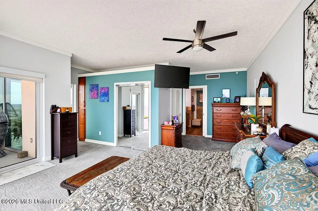 Primary suite with blue accent wall and natural light