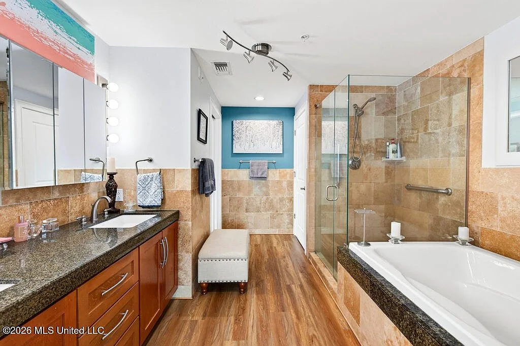 Updated primary bathroom with glass-enclosed shower