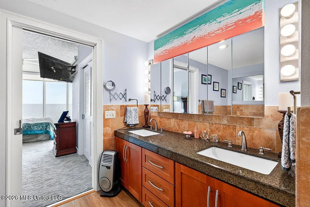 Primary bathroom with double vanity and granite countertops